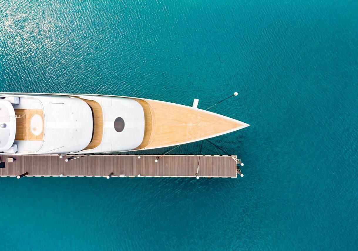 A boat is docked in the water near a pier.